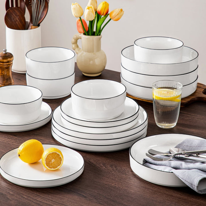 Stacked dinnerware service for 12 with plates, bowls, and mugs arranged for cabinet storage and dining table planning.