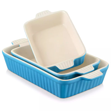 Set of three ceramic baking dishes with beige tops and blue sides on a white background