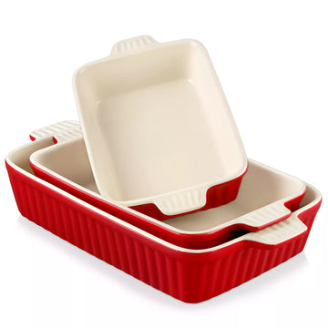 Set of red and beige ceramic baking dishes on a white background