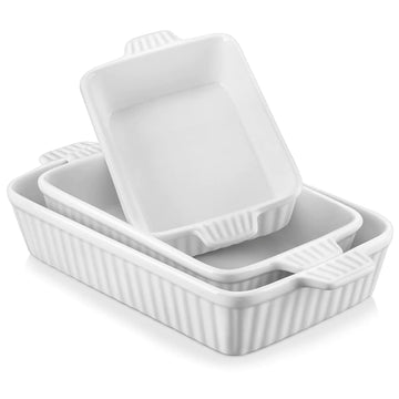 Set of white ceramic baking dishes with lids on a white background