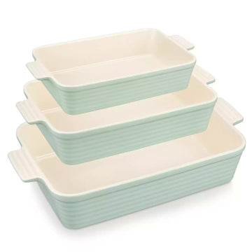 Three light green ribbed porcelain baking dishes with cream interiors