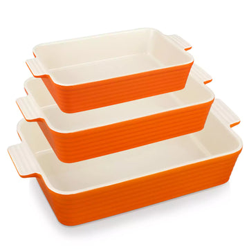 Three orange ribbed porcelain baking dishes with cream interiors