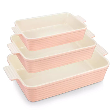 Three pink ribbed porcelain baking dishes with cream interiors