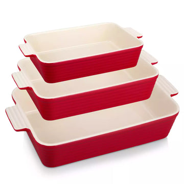 Three red ribbed porcelain baking dishes with cream interiors