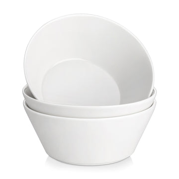 Set of three white ceramic bowls stacked on a white background