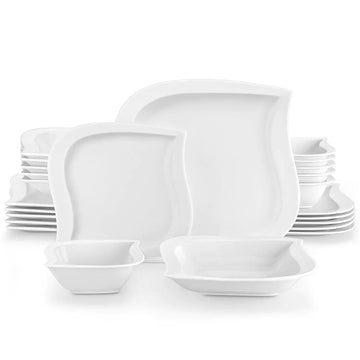 Set of white ceramic dinnerware including bowls and plates on a white background