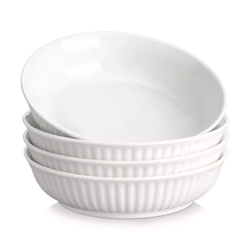 Set of four white ceramic bowls with ribbed texture on a white background#color_ivory-white