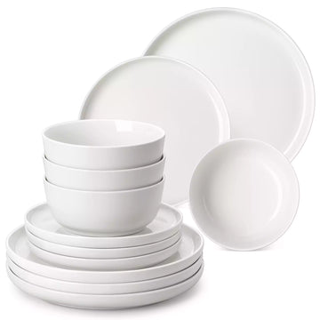 MINA porcelain dinnerware set featuring curved-edge plates and bowls with lifted rims.#color_ivory-white