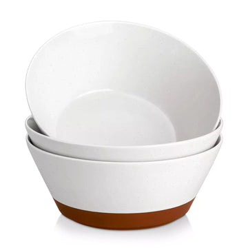 Set of three white bowls with brown bottoms on a white background