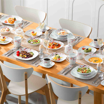 Creazione di un tavolo estivo colorato con eleganti stoviglie in porcellana bianca