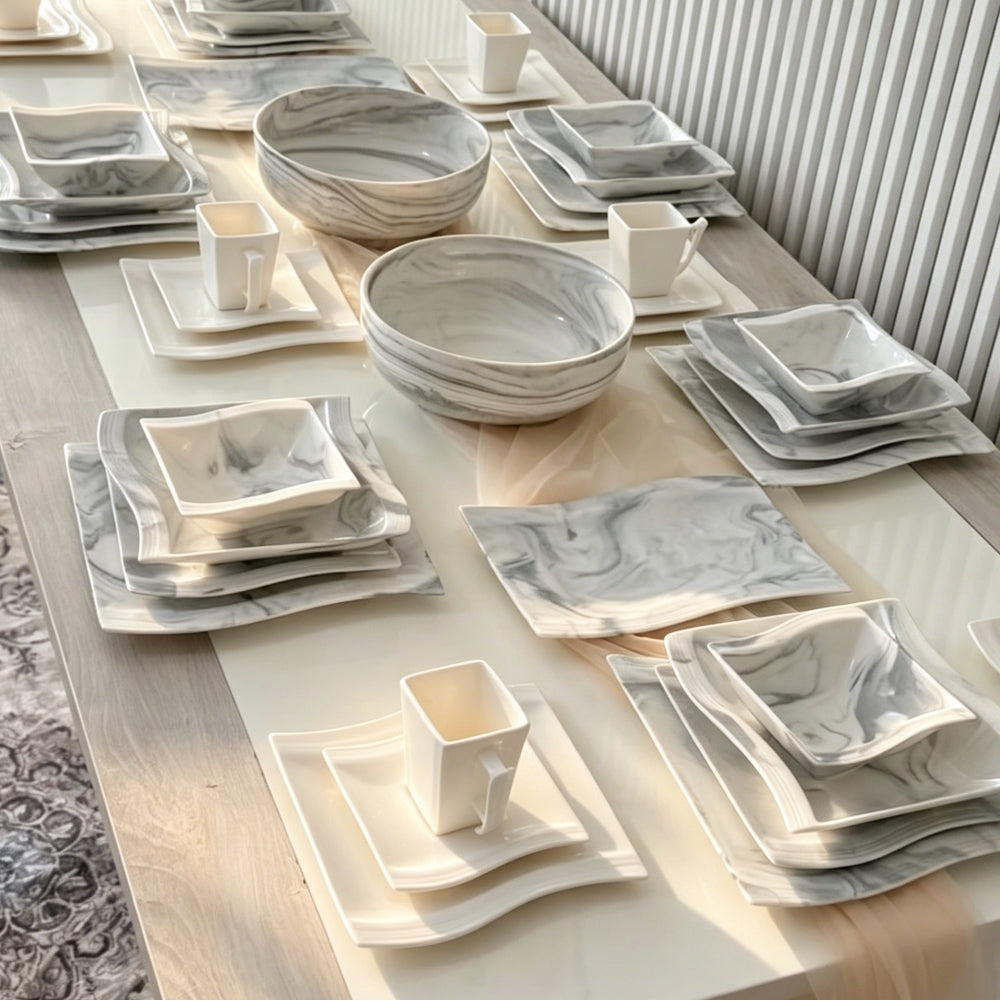 Ceramic serving platters set including a white oval platter and rectangular platter styled with roasted meat, fresh vegetables and appetizers for family-style dining.