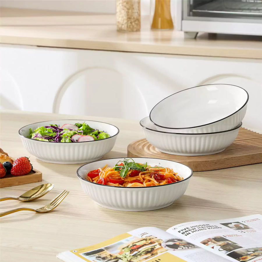 Wide white pasta bowl filled with spaghetti and tomato sauce, styled on a simple table setting — illustrating how white pasta bowls work as versatile everyday dinnerware for one-bowl meals.