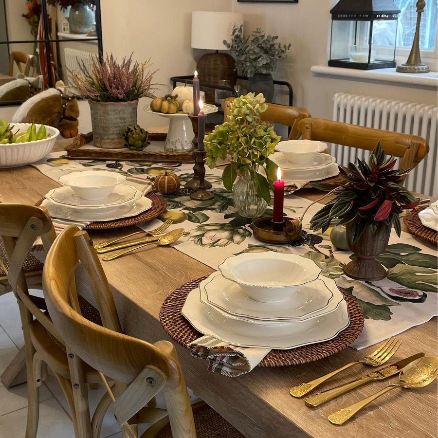 A curated display of aesthetic dinnerware arranged for a dinner party, featuring porcelain, stoneware, and modern tableware styles.
