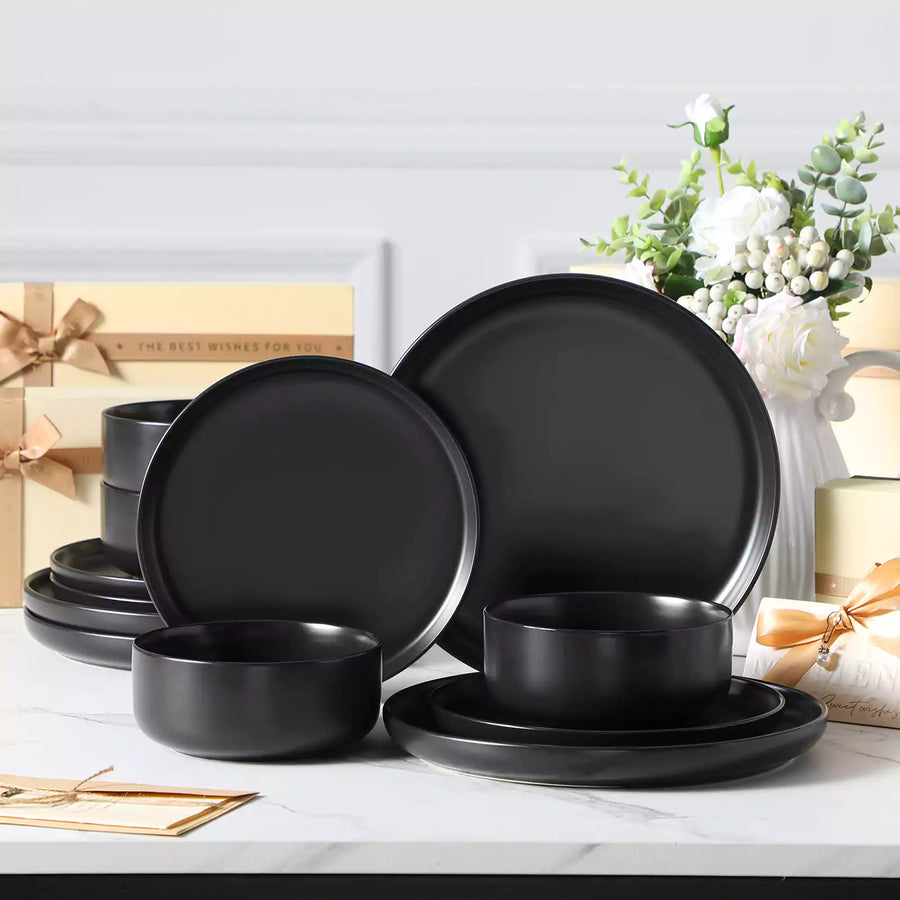 Modern matte dinnerware sets in black and grey stoneware, styled with metallic cutlery for an elegant table setting