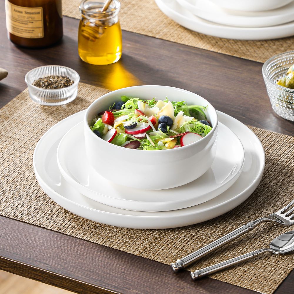 White porcelain Chinese rice bowls, noodle bowls, and small side bowls with rice, noodle soup, and home-style dishes, showing their uses in everyday Chinese meals.