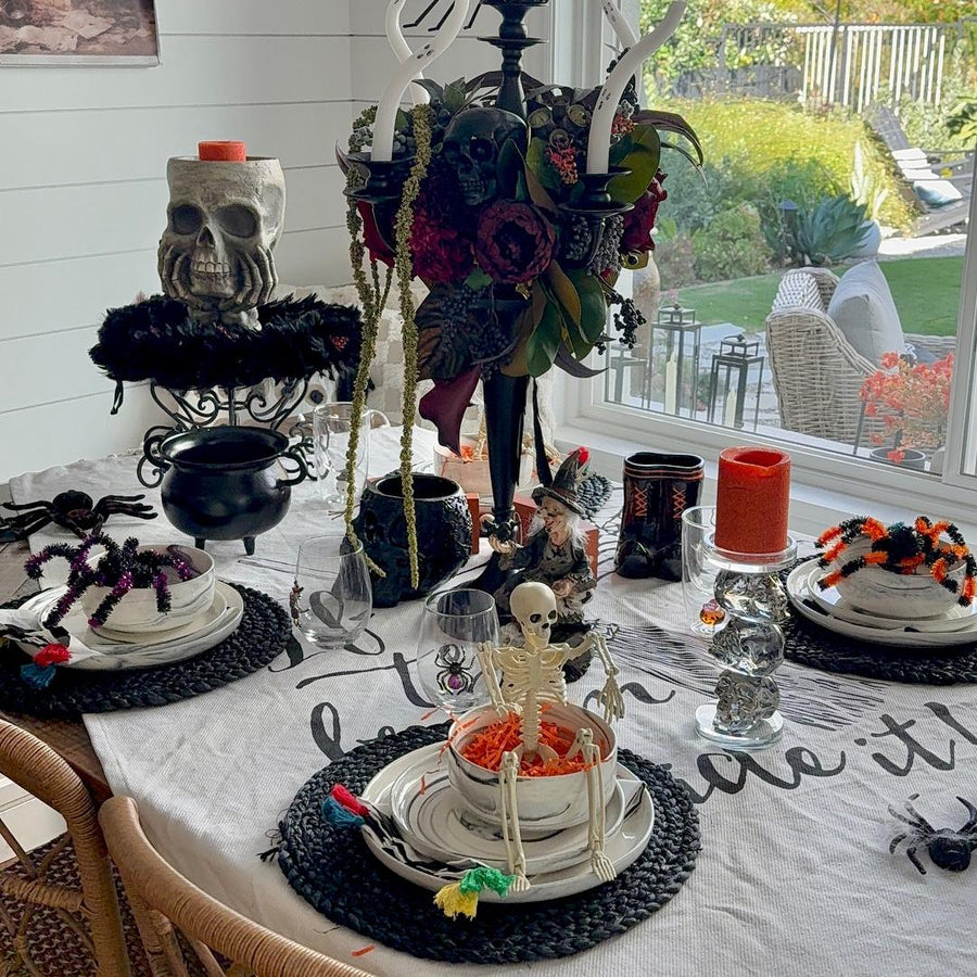 Modern dinnerware sets styled for a chic Halloween table setting, combining grey and square plates for a contemporary festive look.