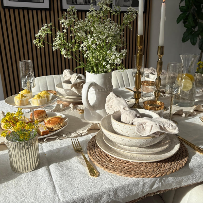 A variety of commercial dinnerware sets displayed on a restaurant table, showcasing different plate styles and materials used in professional food service.