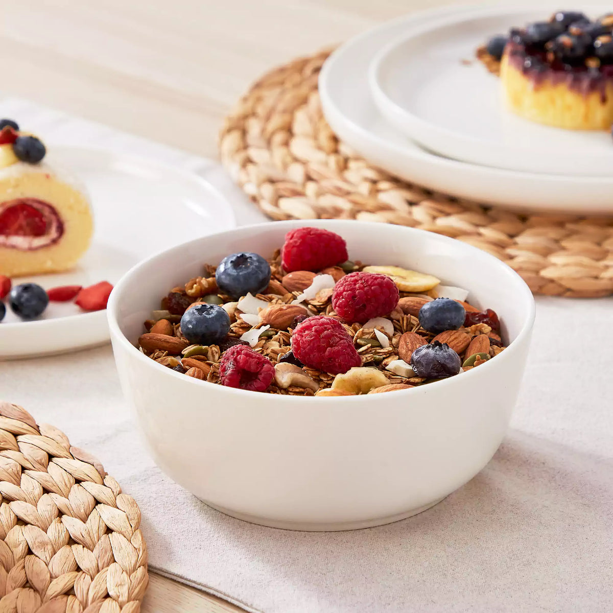 A healthy breakfast bowl with layered grains, fruit, and yogurt served in a porcelain bowl