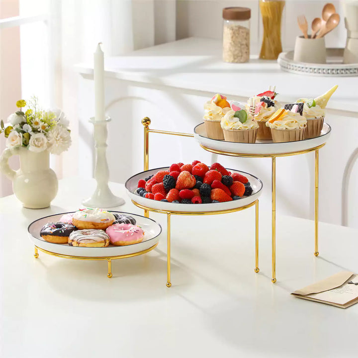 A white porcelain 3-tier serving tray holding sandwiches, pastries, fruit, and afternoon tea treats, showing a space-saving tiered serving setup.
