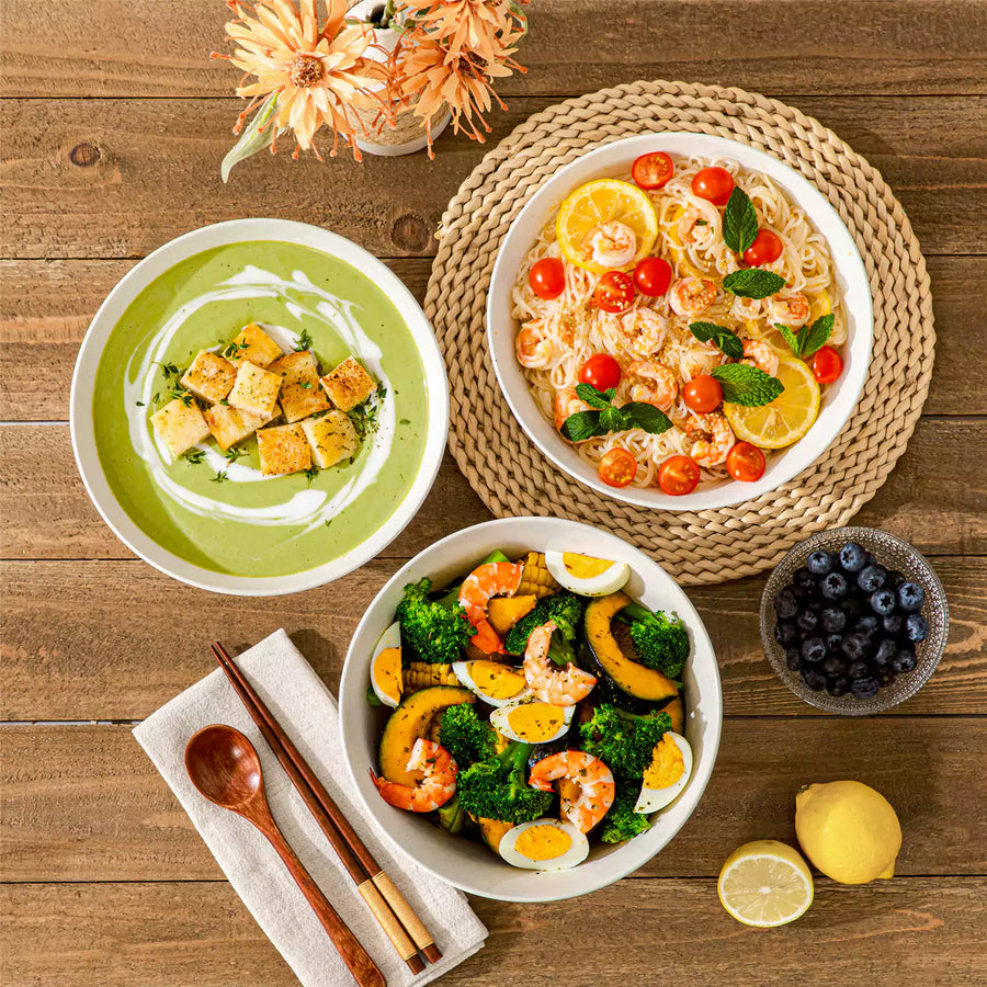 A stack of large white ceramic soup bowls filled with hearty soup, showcasing durable dinnerware perfect for stews, ramen, and everyday meals