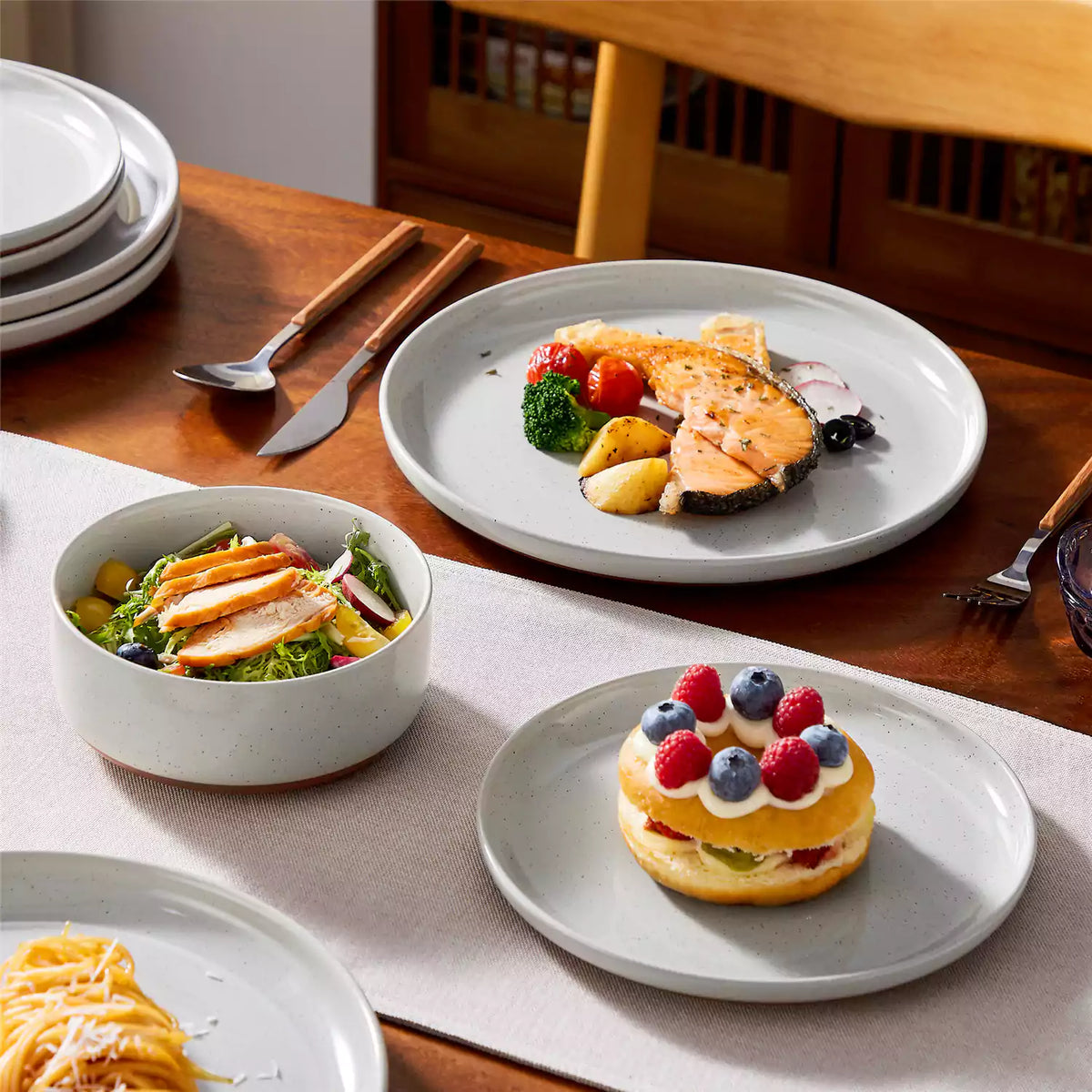 A beautifully set brunch table featuring elegant porcelain plates and bowls, showcasing essential dinnerware for hosting a perfect brunch.