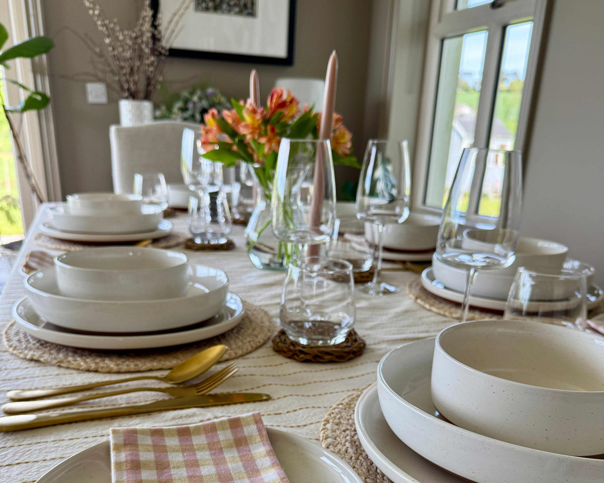 Tara 32-piece stoneware dinnerware set with glossy sesame glaze and matte earthy base, styled on a modern dining table