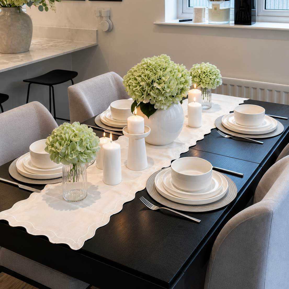 A neatly arranged set of white porcelain plates and bowls on a dining table, representing durable, lead-free sustainable dinnerware for eco-friendly kitchens.