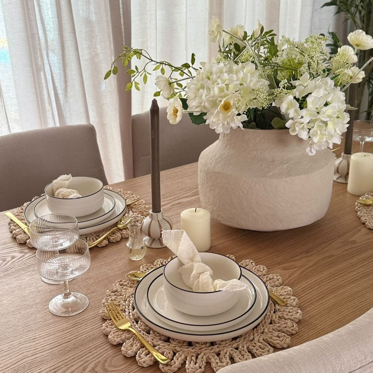 Modern St Patricks Day dinner table with white dinnerware sets, green decor, and oven safe dishes for an Irish dinner party at home
