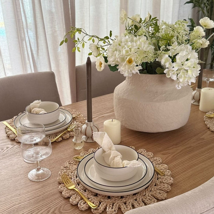 Modern St Patricks Day dinner table with white dinnerware sets, green decor, and oven safe dishes for an Irish dinner party at home