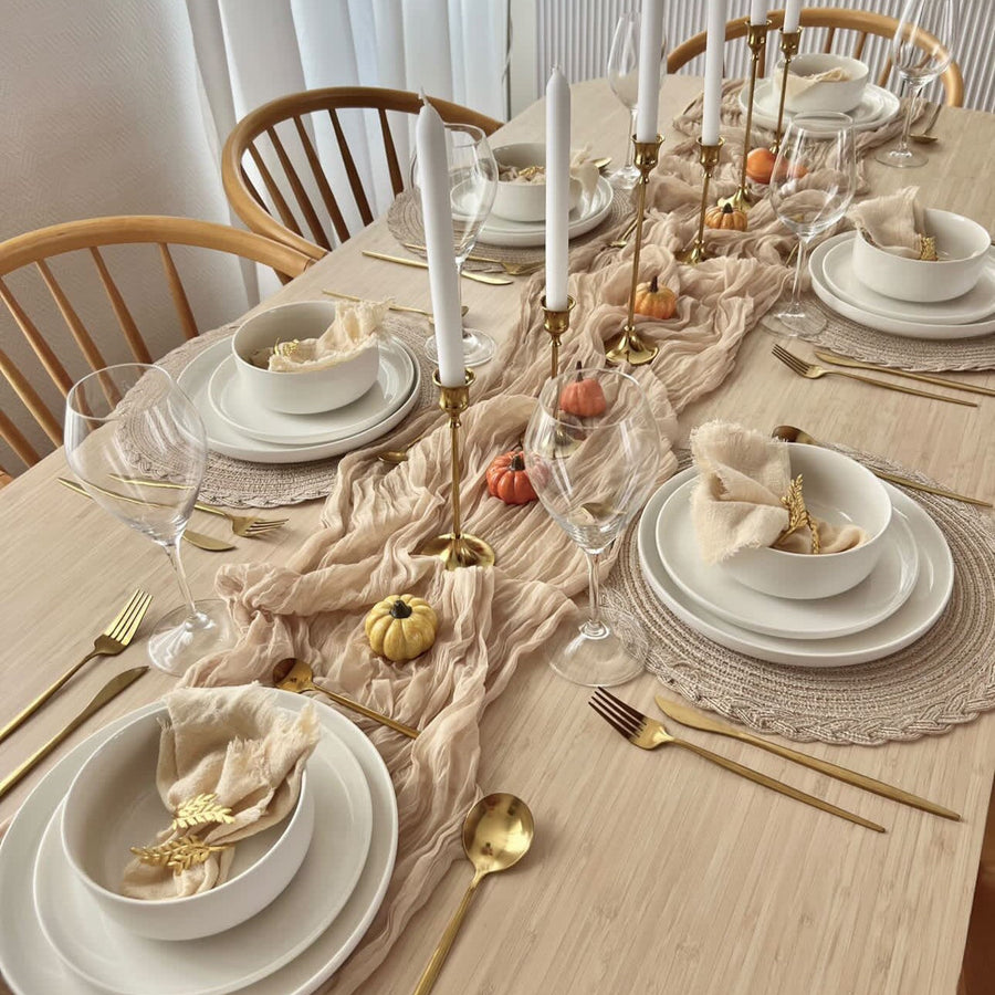 An elegant Lunar New Year dinner party table featuring ivory porcelain dinnerware, round plates, and festive red accents for family-style dining.