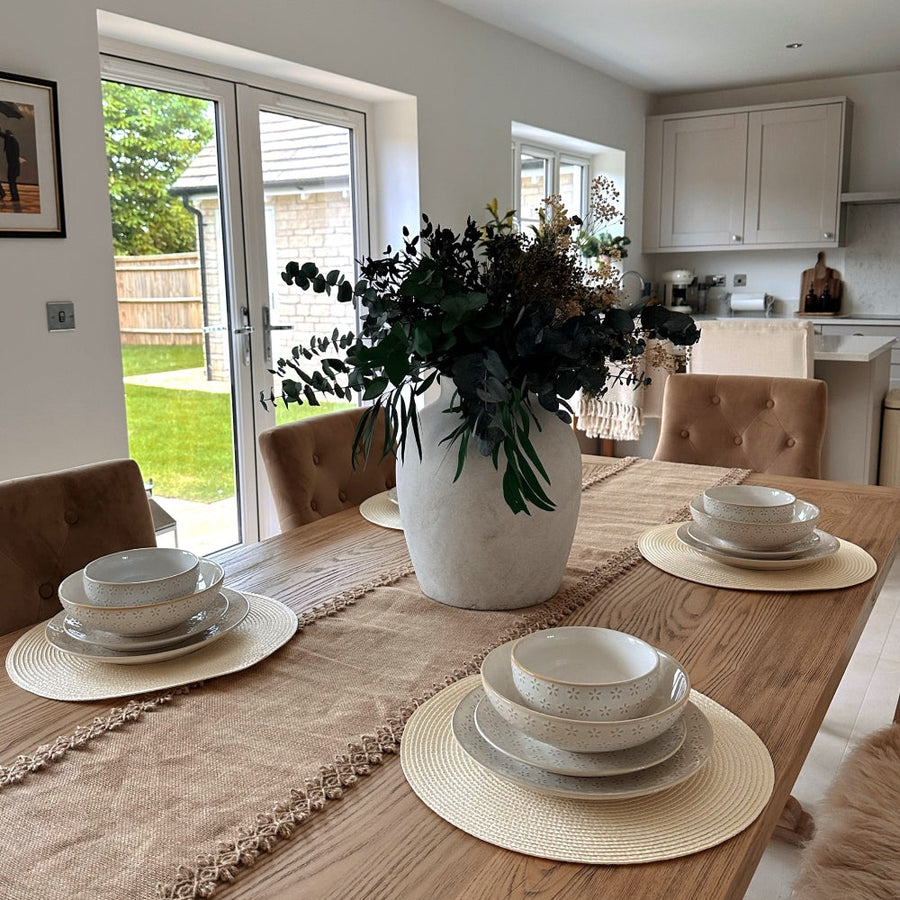 Japandi table setting inspired by Japanese minimalism and Scandinavian functionality, focusing on neutral tones, stoneware dinnerware, and a calm dining atmosphere