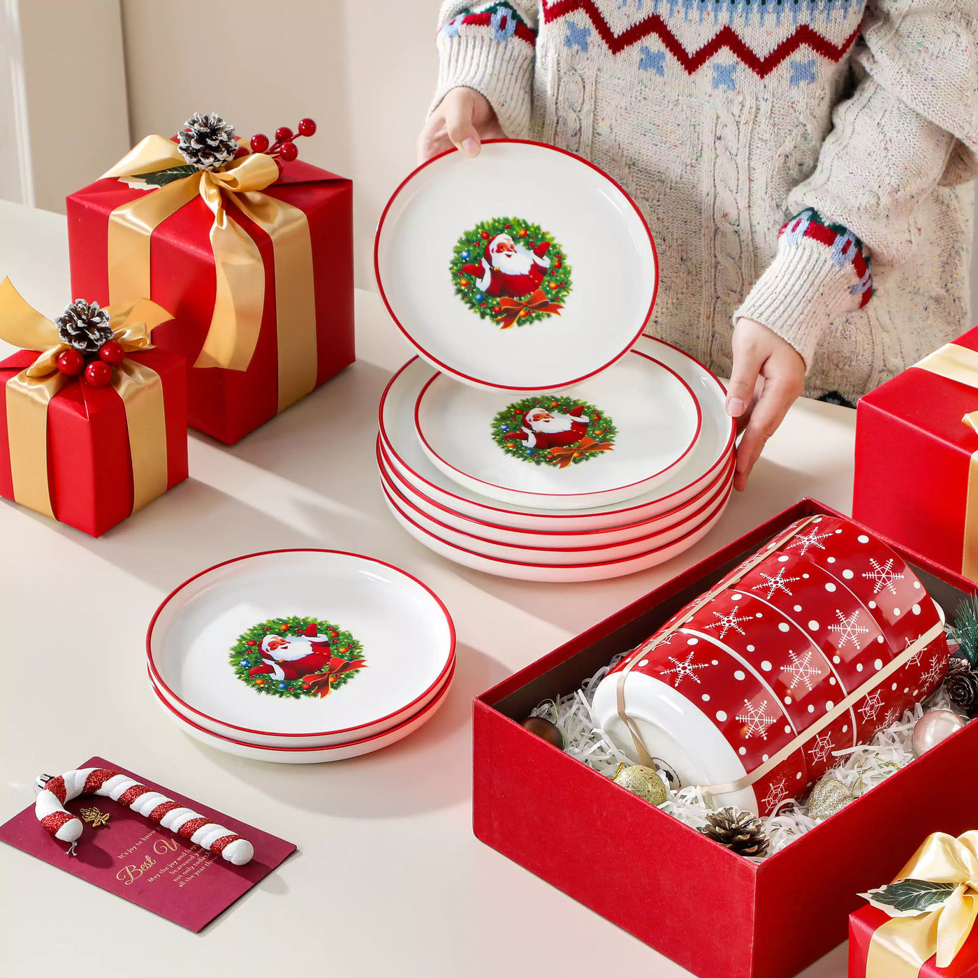 12-piece porcelain Christmas dinnerware set featuring a cheerful Santa Claus design surrounded by playful snowflakes and polka dots, including dinner plates, salad plates, and cereal bowls for four.