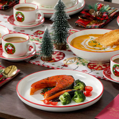 30-piece Christmas porcelain dinnerware set with a joyful Santa Claus motif, snowflakes, and polka dots; includes dinner plates, salad plates, soup plates, cups, and saucers for six guests.