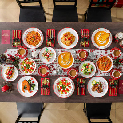 30-piece Christmas porcelain dinnerware set with a joyful Santa Claus motif, snowflakes, and polka dots; includes dinner plates, salad plates, soup plates, cups, and saucers for six guests.