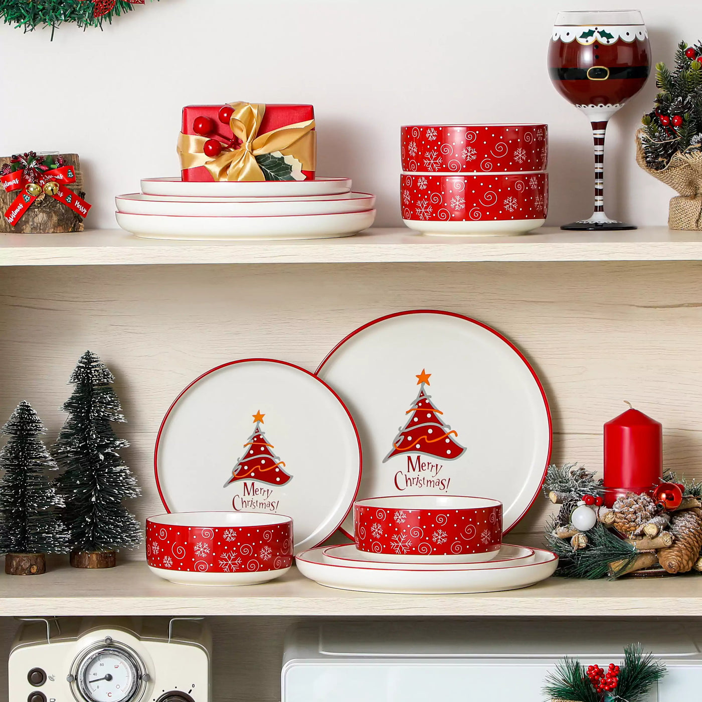 12-piece porcelain dinnerware set from the Christmas Collection, featuring a red Christmas tree topped with a gold star and surrounded by delicate snowflakes; includes plates and bowls for four.