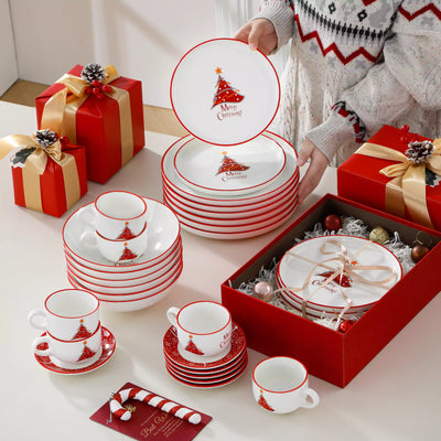 30-piece porcelain Christmas dinnerware set showcasing a red Christmas tree with a gold star and snowflake accents; includes dinner plates, salad plates, soup plates, cups, and saucers for six.