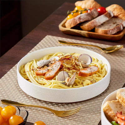 Leah 4-piece stoneware pasta bowls set with speckled glaze, non-slip bases, microwave, oven, and dishwasher safe, available in ivory and multicolor.#color_white