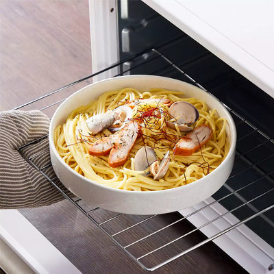Leah 4-piece stoneware pasta bowls set with speckled glaze, non-slip bases, microwave, oven, and dishwasher safe, available in ivory and multicolor.#color_white