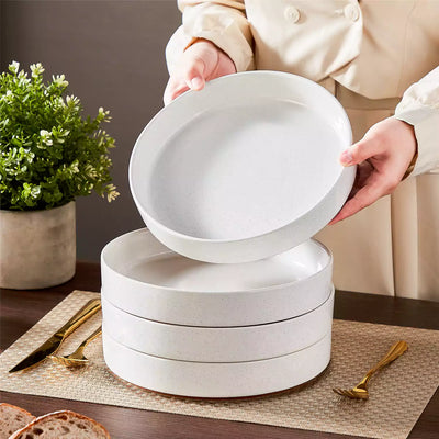 Leah 4-piece stoneware pasta bowls set with speckled glaze, non-slip bases, microwave, oven, and dishwasher safe, available in ivory and multicolor.#color_white