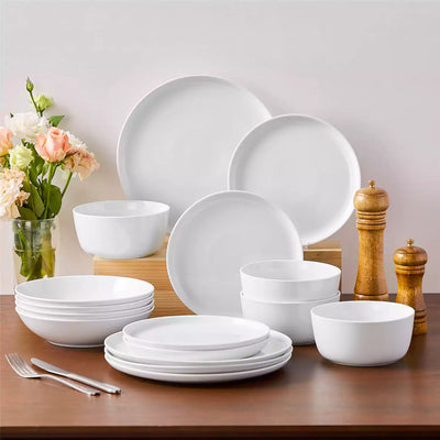 LEXI off-white porcelain dinnerware set including arc-shaped plates with lifted rims and deep rounded bowls#color_white