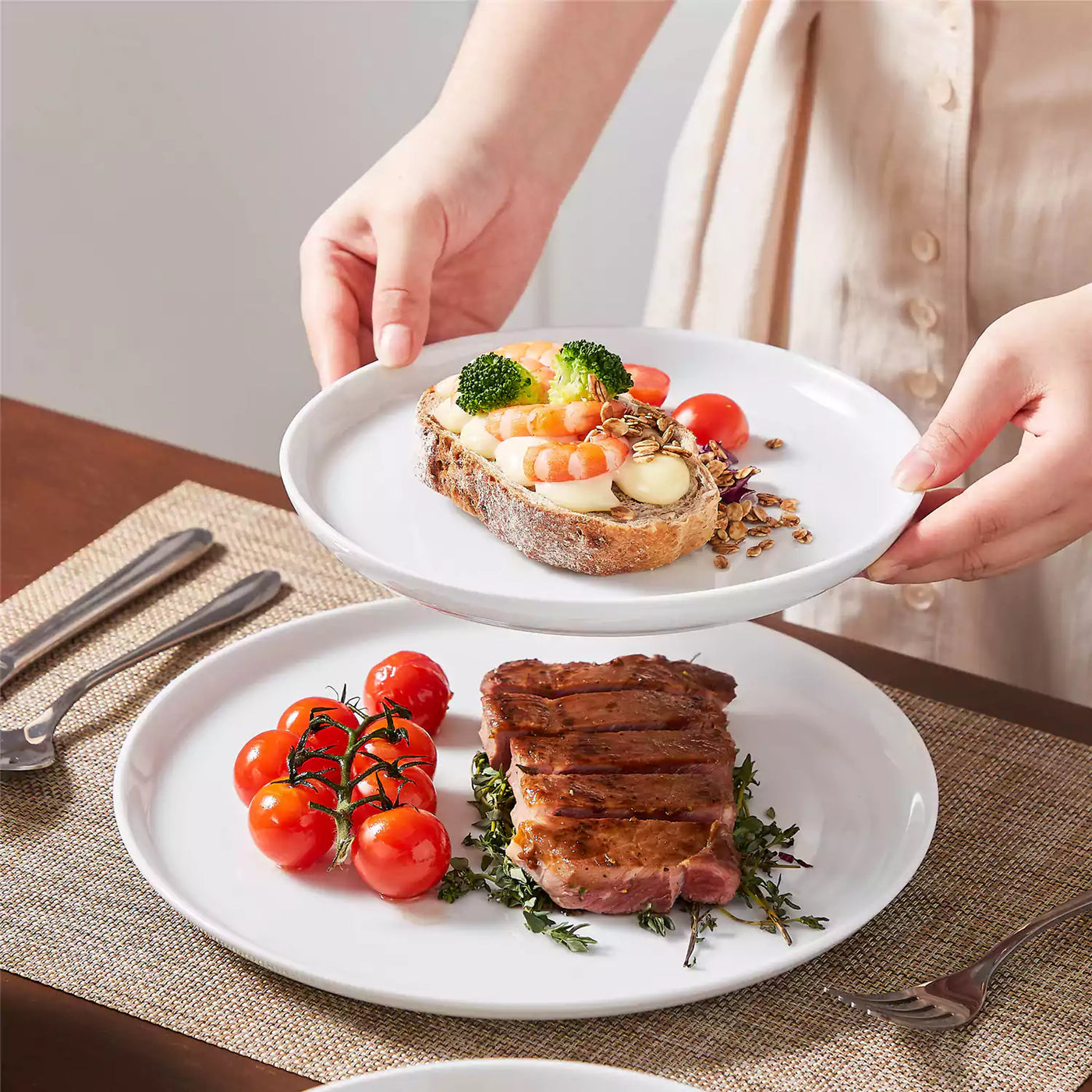 LEXI off-white porcelain dinnerware set including arc-shaped plates with lifted rims and deep rounded bowls#color_white