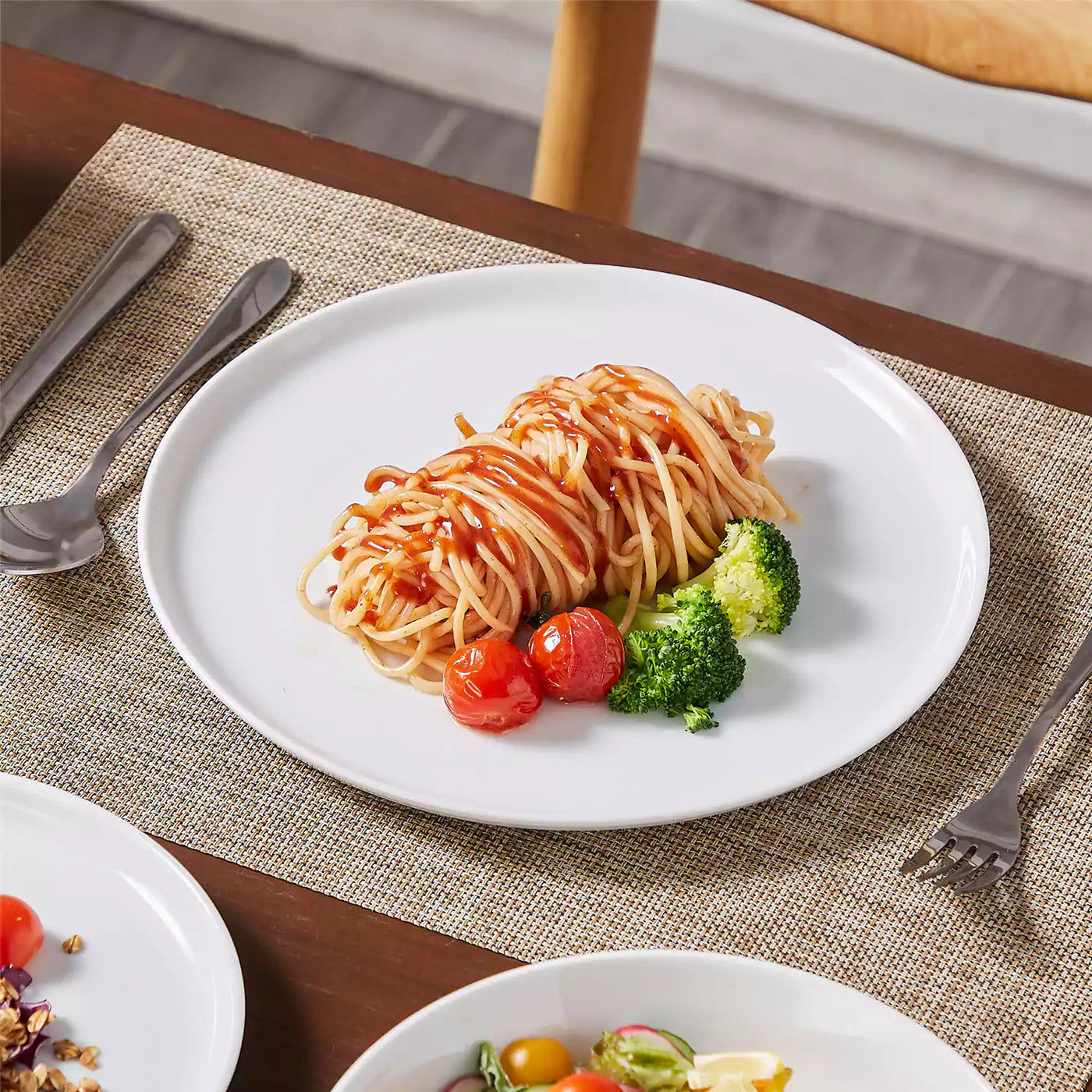 LEXI off-white porcelain dinnerware set including arc-shaped plates with lifted rims and deep rounded bowls#color_white