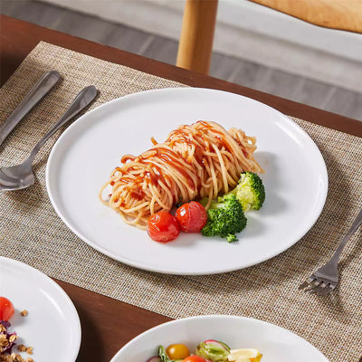 LEXI off-white porcelain dinnerware set including arc-shaped plates with lifted rims and deep rounded bowls#color_white