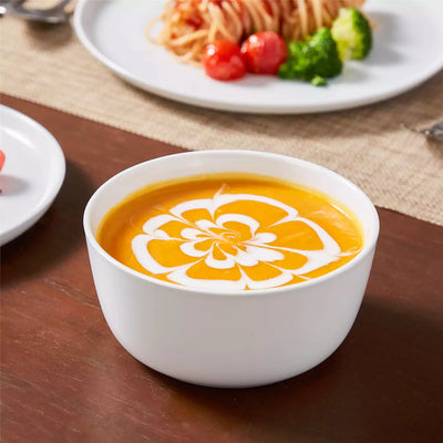 LEXI off-white porcelain dinnerware set including arc-shaped plates with lifted rims and deep rounded bowls#color_white