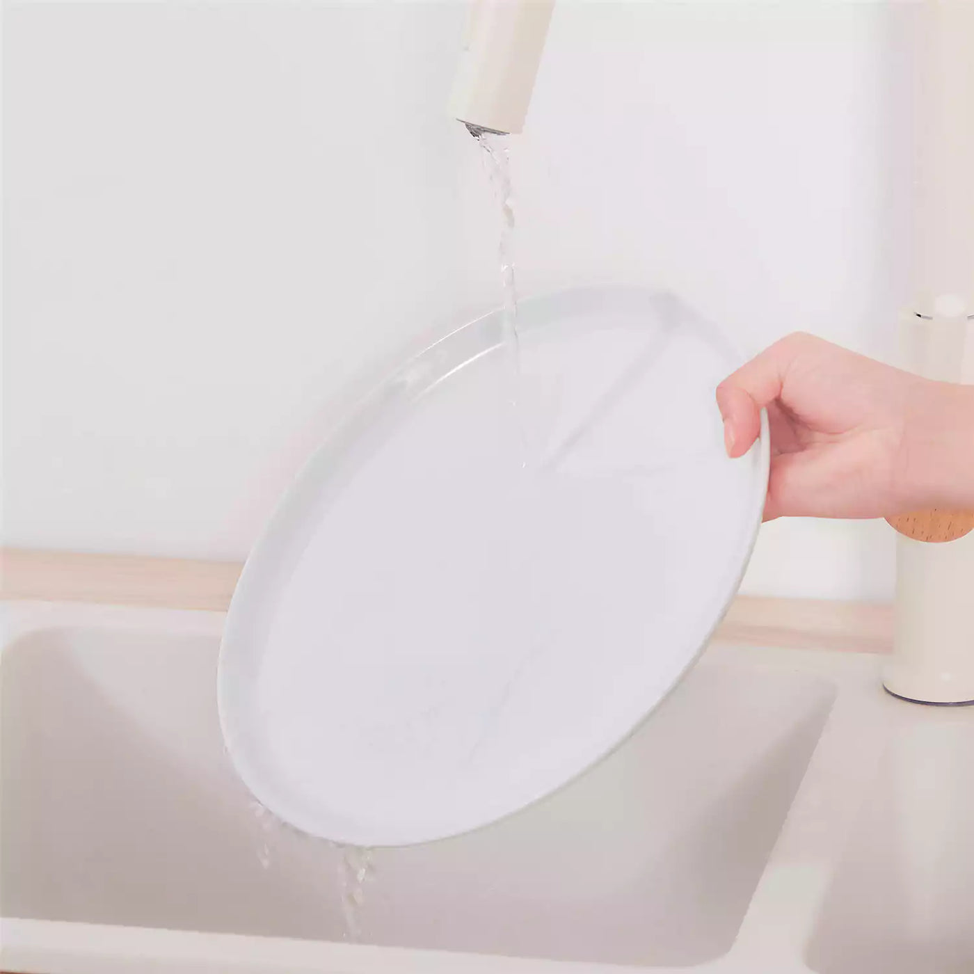 LEXI off-white porcelain dinnerware set including arc-shaped plates with lifted rims and deep rounded bowls#color_white