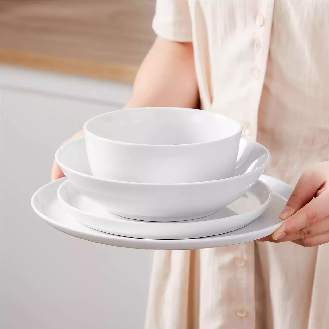 LEXI off-white porcelain dinnerware set including arc-shaped plates with lifted rims and deep rounded bowls#color_white