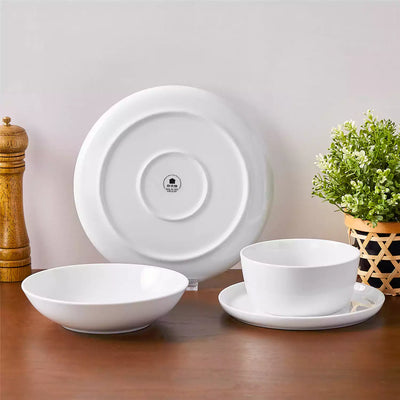 LEXI off-white porcelain dinnerware set including arc-shaped plates with lifted rims and deep rounded bowls#color_white