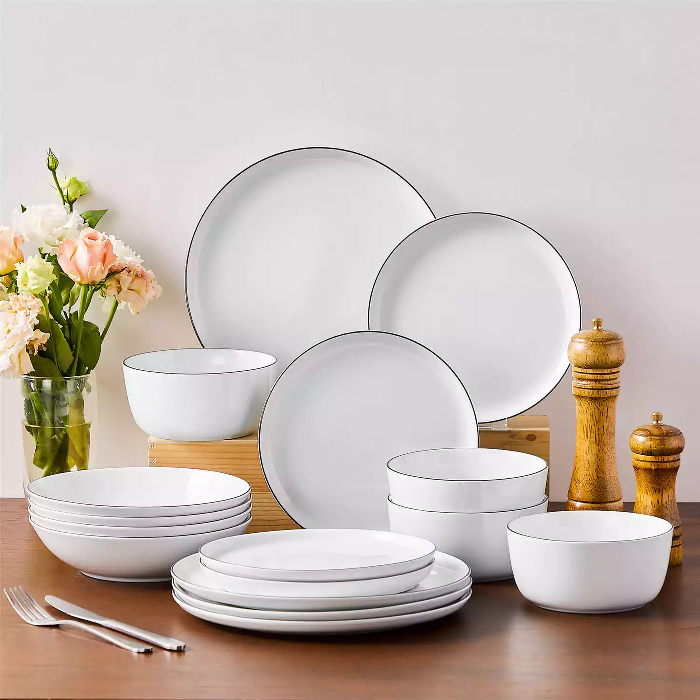 LEXI off-white porcelain dinnerware set including arc-shaped plates with lifted rims and deep rounded bowls#color_black-trim