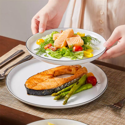 LEXI off-white porcelain dinnerware set including arc-shaped plates with lifted rims and deep rounded bowls#color_black-trim