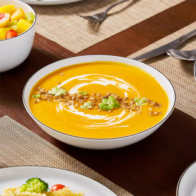 LEXI off-white porcelain dinnerware set including arc-shaped plates with lifted rims and deep rounded bowls#color_black-trim